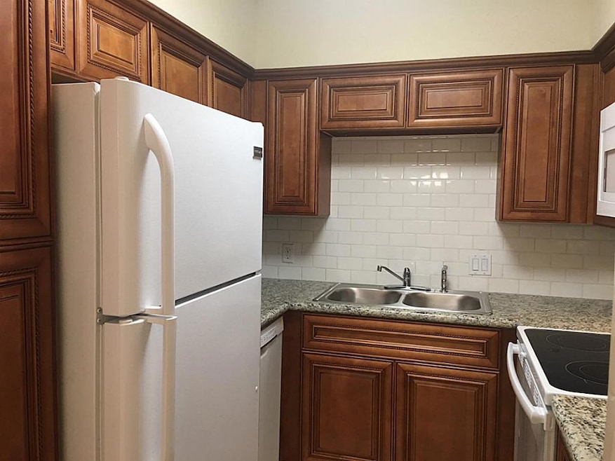 Updated kitchen with subway tile backsplash and granite. Beautiful new cabinetry, too.