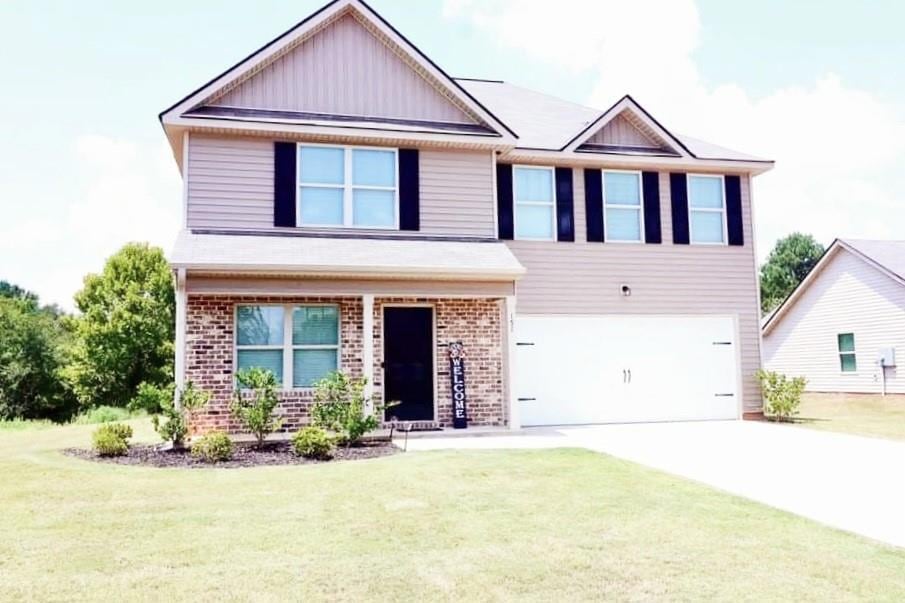 View of front of house featuring a garage and a fr