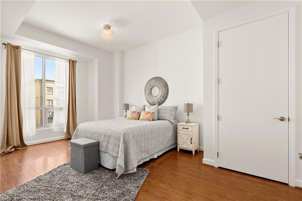 Bedroom with hardwood / wood-style flooring