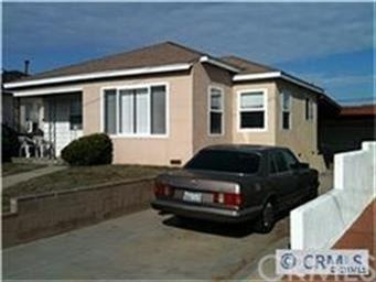 Front view of home with long driveway leading to d
