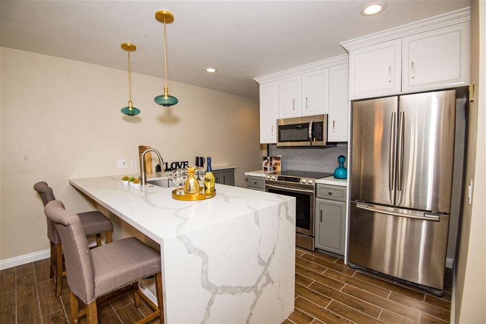With a waterfall edge quartz calcutta slab