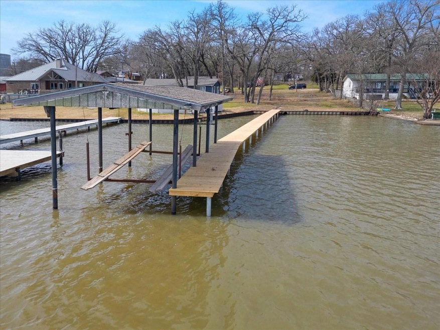 Dock area with a water view and boat lift