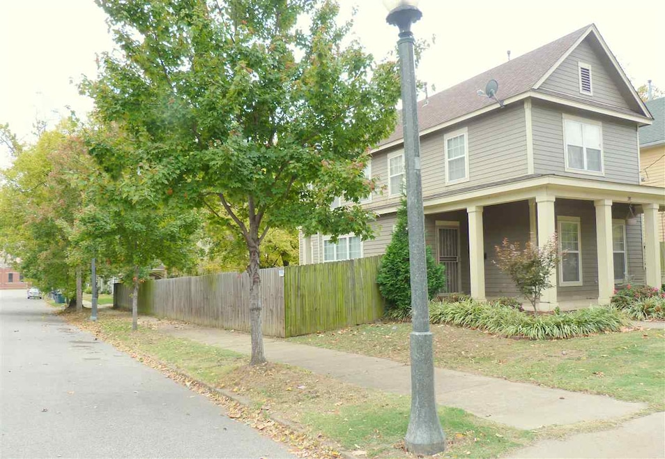 Spacious corner lot on a tree-lined street, with c