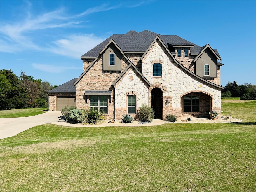Pretty, Tudor style home featuring stone and brick