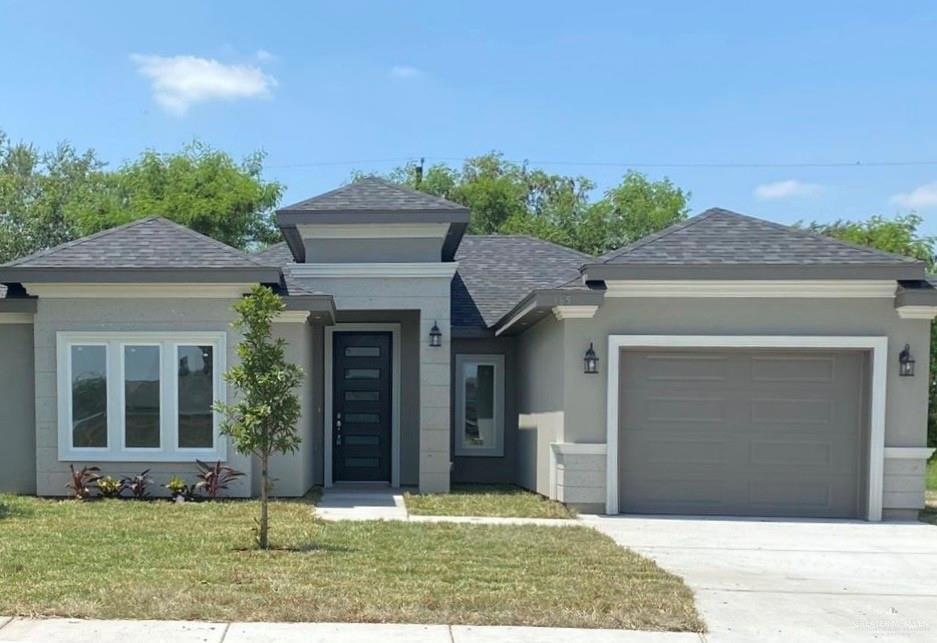 Prairie-style house with a garage and a front yard