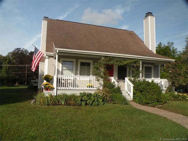 Roses and perennial flowers surround the front doo