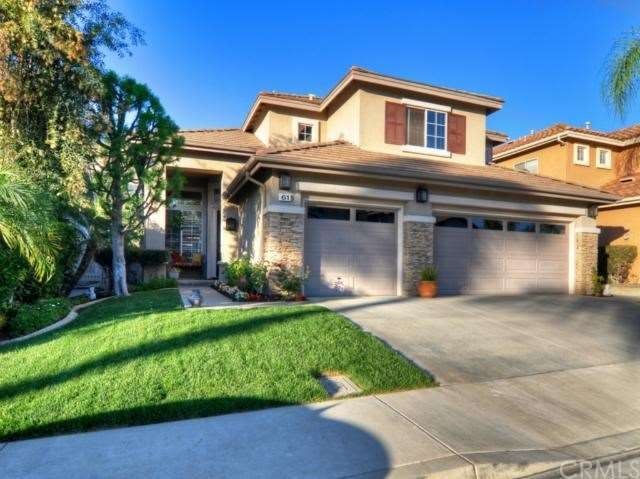 Large front grassy area and large shade trees grac