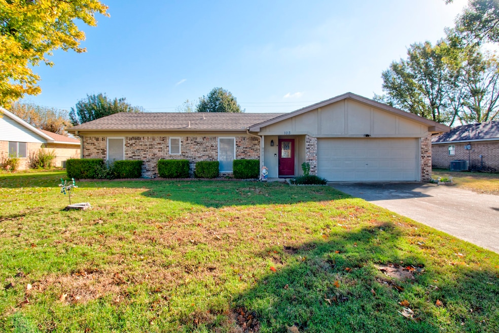 Ranch-style house with concrete driveway, a front lawn, board and batten siding, and a garage