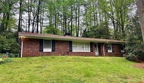 Single story home featuring a front lawn
