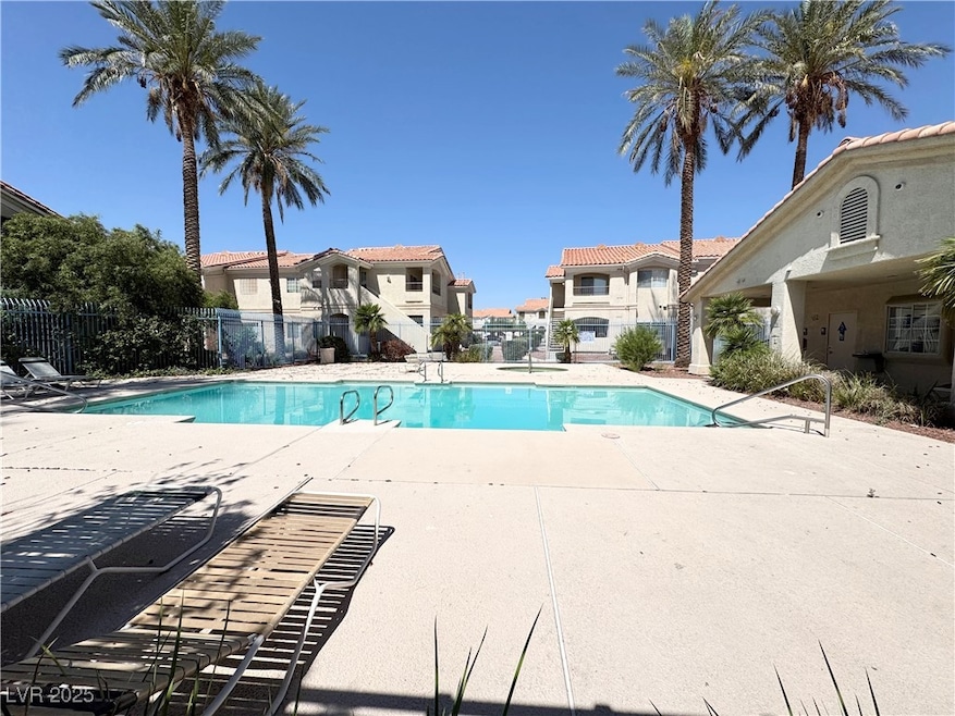 Community pool with a patio and a residential view