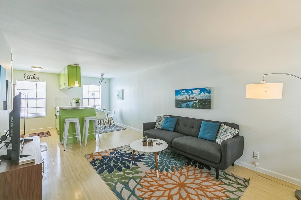 Living room with light wood-style floors and base