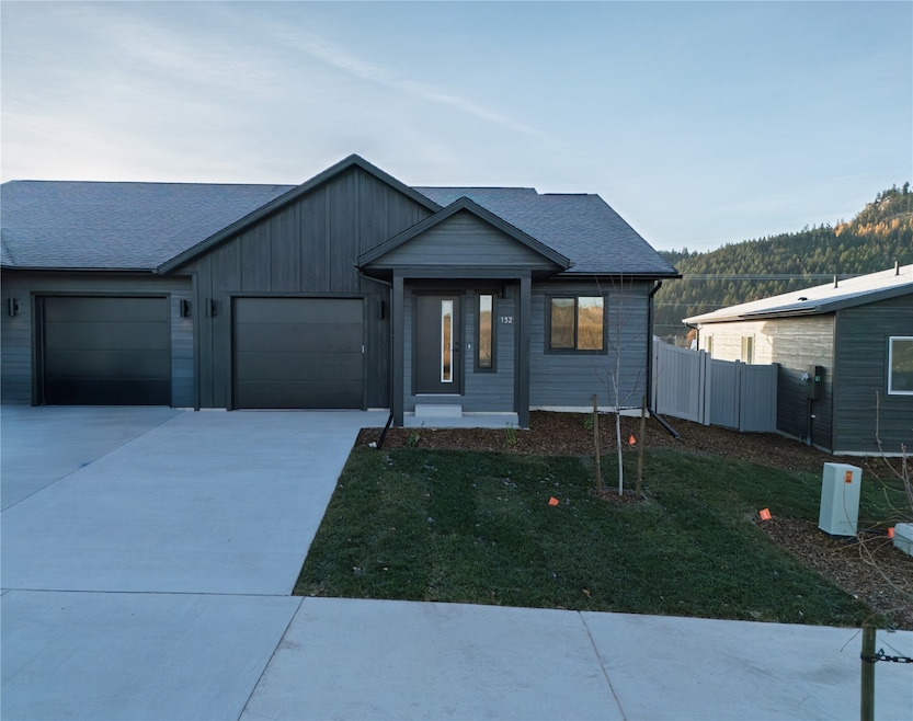 Ranch-style house featuring driveway, a garage, board and batten siding, and a shingled roof