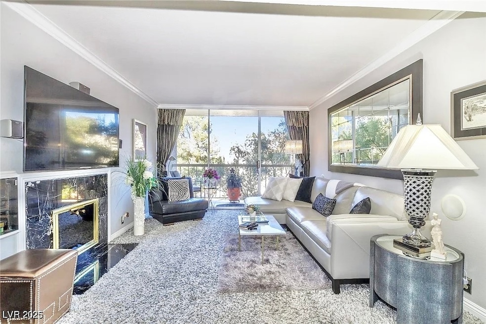 Living room featuring ornamental molding, baseboar