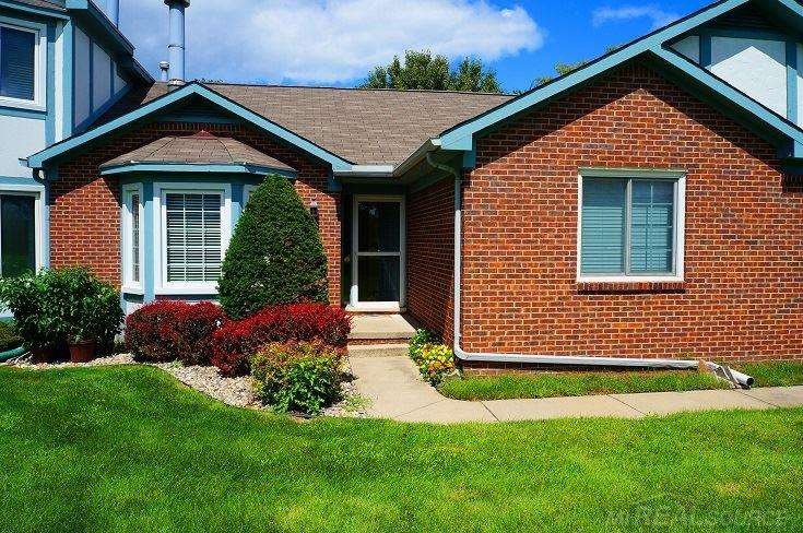 Front of condo opens to large green grassy area