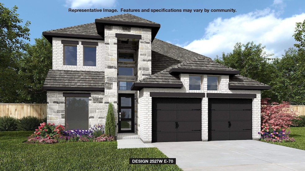 View of front of home with stone siding, a garage