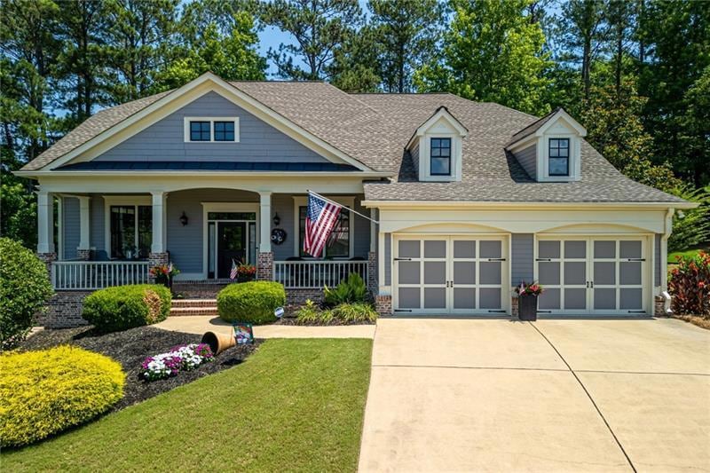 View of front of home with a garage, a front lawn,