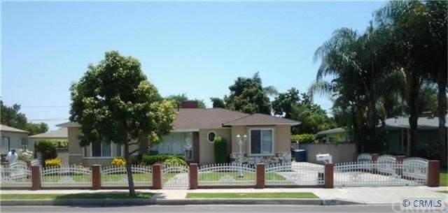 Electric gate and long driveway on the side of the