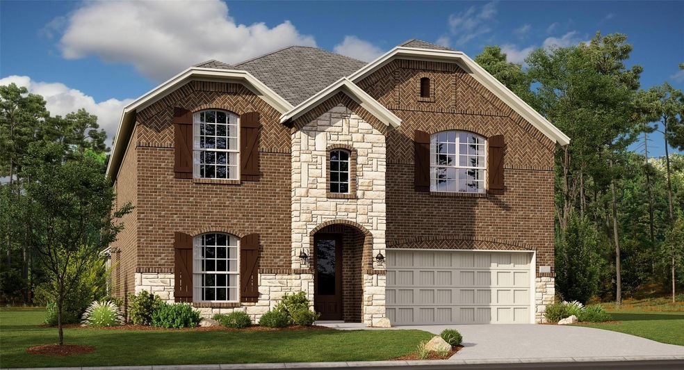 View of front facade with a garage and a front law