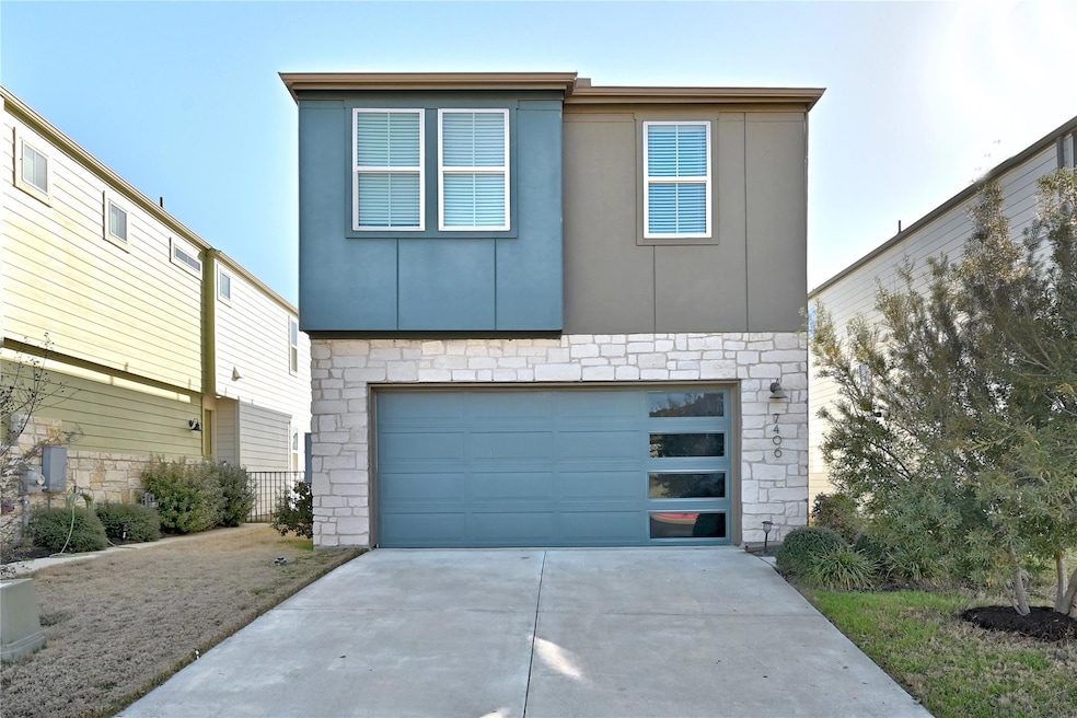 Contemporary house with a garage, stone siding, d
