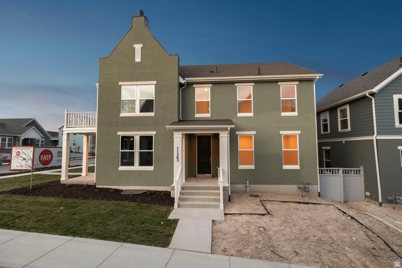 Traditional home with stucco siding and a chimney
