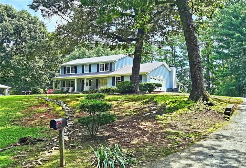View of front of property featuring a garage and c
