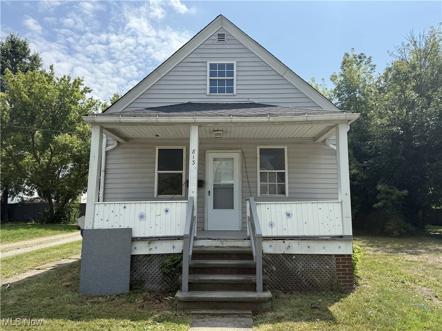 Bungalow-style home featuring covered porch and a front yard