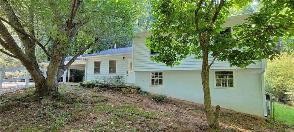View of property exterior featuring a carport