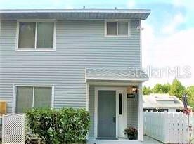 Front entrance, pool behind fence.