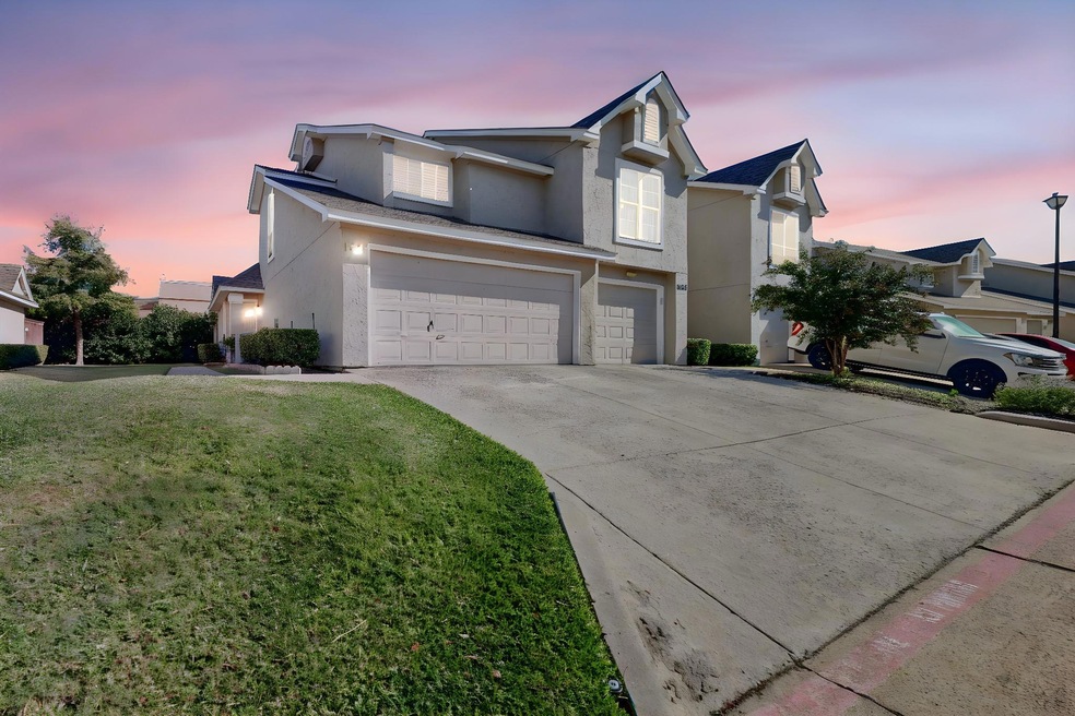 View of front property featuring a garage and a ya