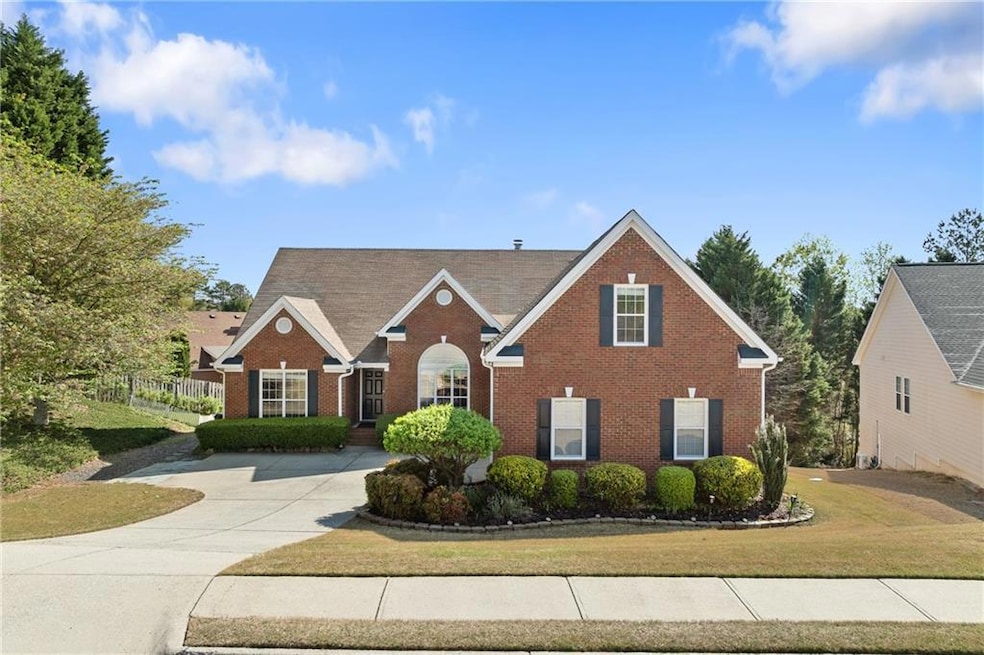 Traditional-style home featuring brick siding, a f