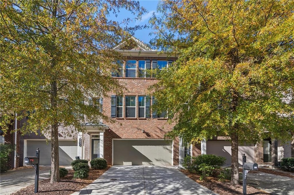 View of front of property with brick siding, concrete driveway, and a garage
