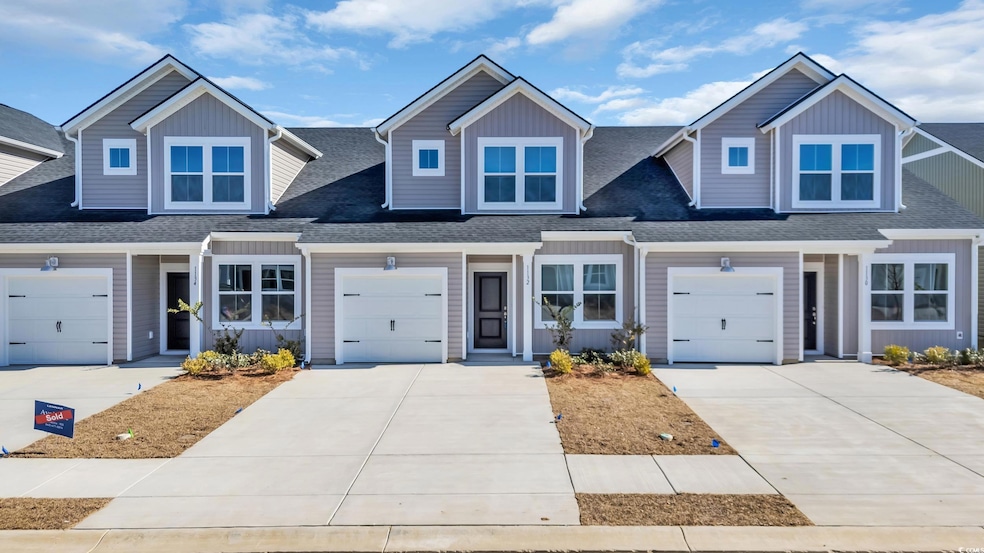 Craftsman house with a garage, driveway, and roof 