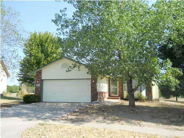 Nestled between two shade trees is this well-maint