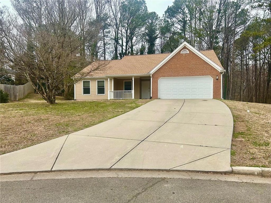 Ranch-style home with brick siding, covered porch,