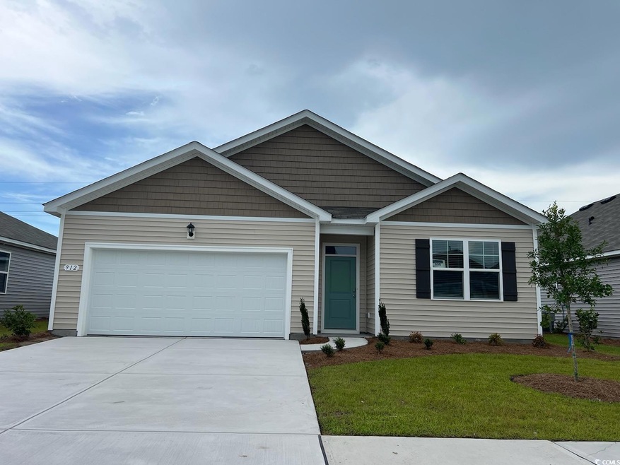View of front of house with a garage and a front y