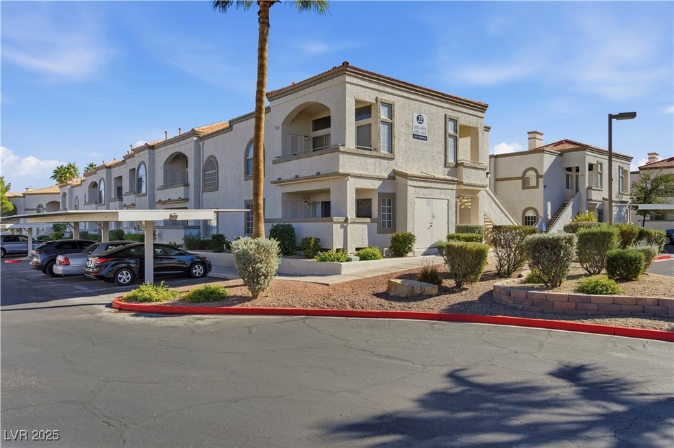 View of building exterior with covered parking, a residential view, and stairs