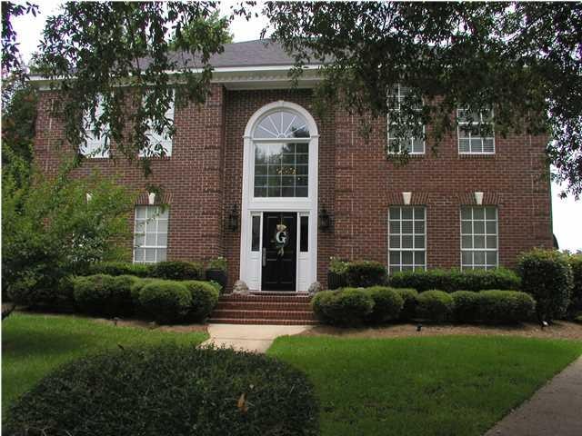 This stately home with quoins, arched windows, and