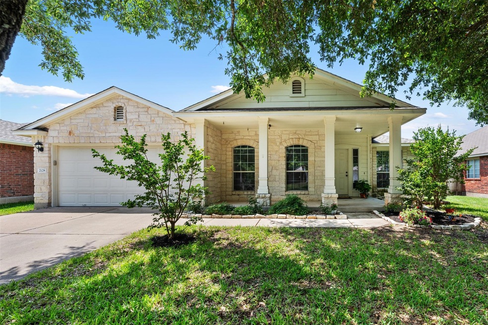 View of front facade with concrete driveway, an a