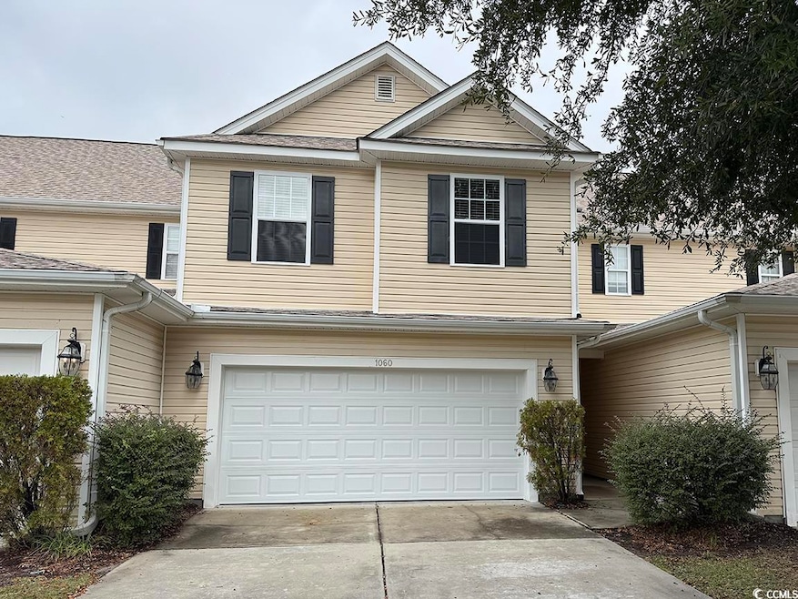 View of front of home featuring an attached garage and driveway