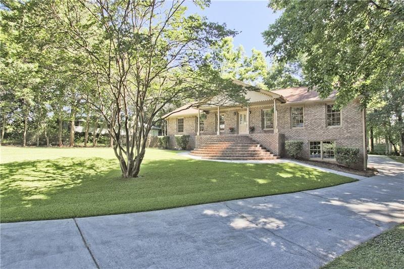 This elegant brick ranch is on a beautiful lot in 