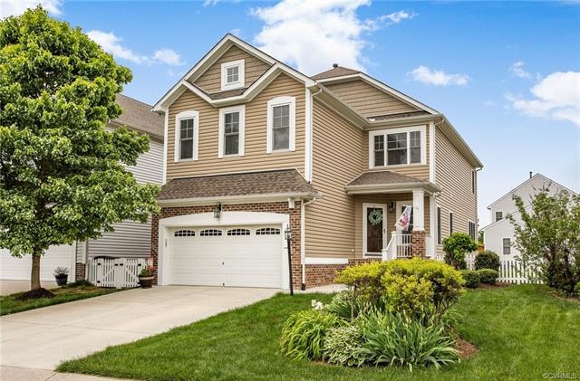 Beautiful landscaping dresses up this brick and vinyl sided home in Hawthorne Village at Charter Colony.