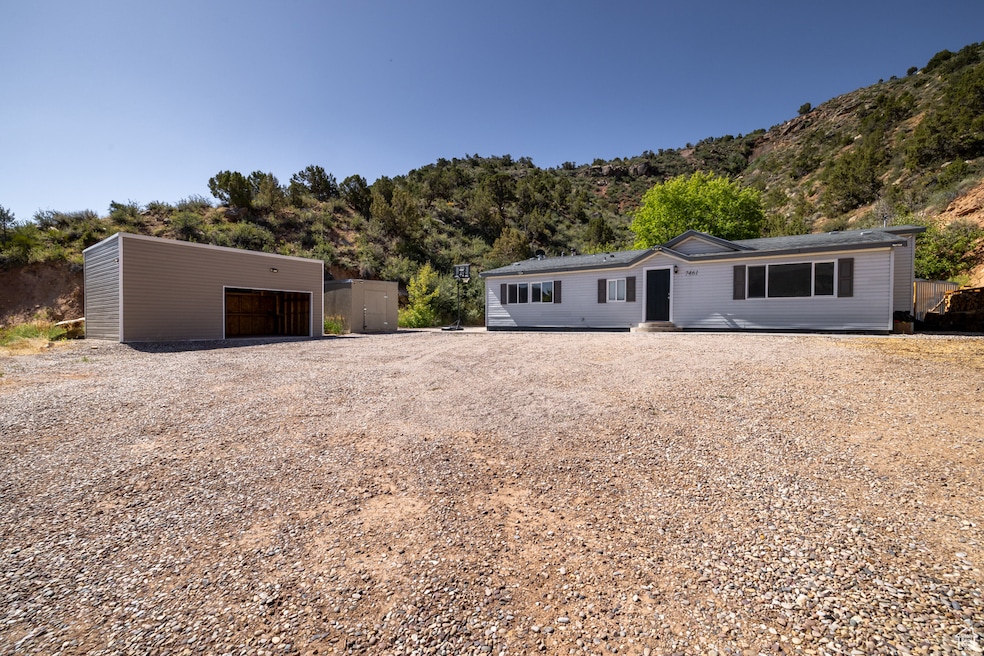 View of front of property with a garage, an outbuilding, and a mountain view