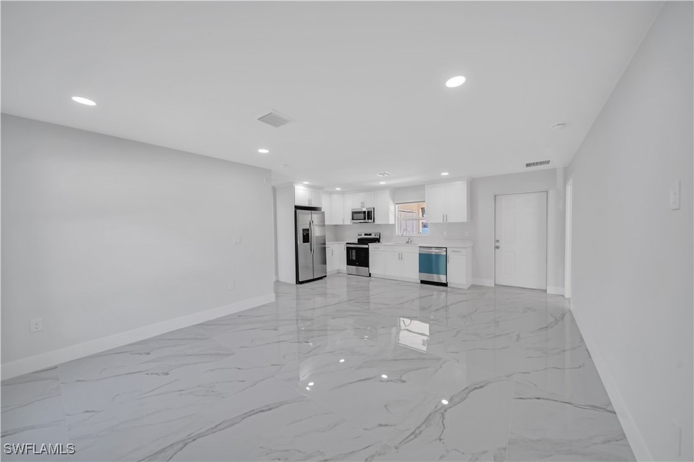 Unfurnished living room featuring marble finish fl