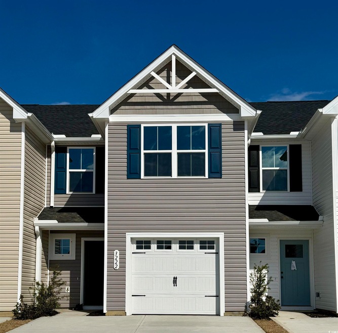 Multi unit property with a garage and concrete dri