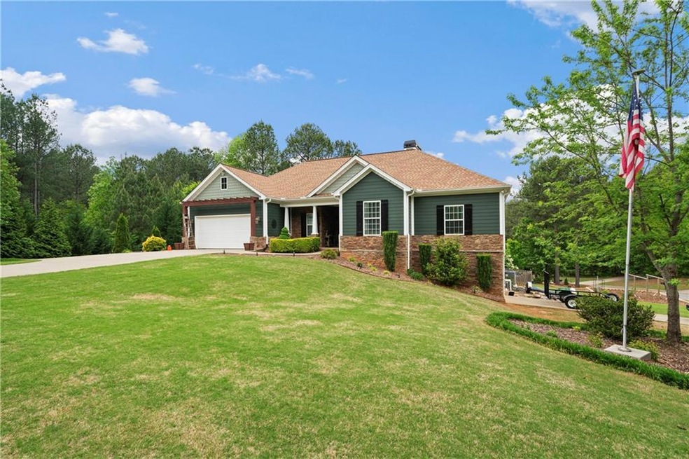 Craftsman house with a front yard and a garage