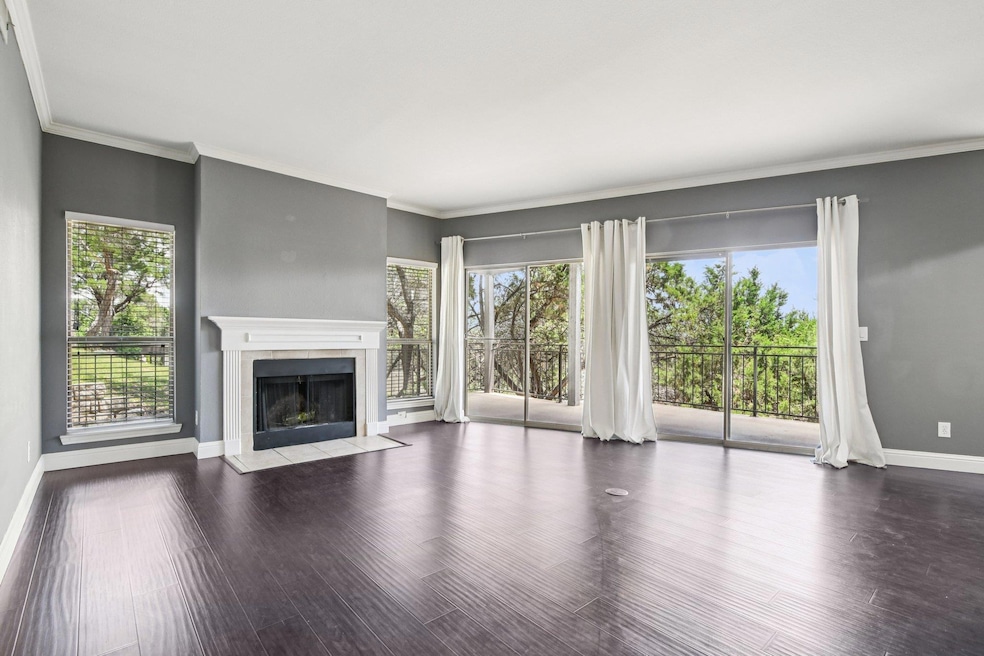 Unfurnished living room featuring a tile fireplac
