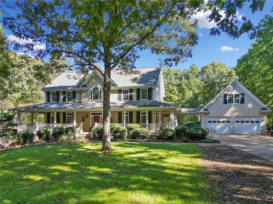 View of front of home with a front yard and a porc