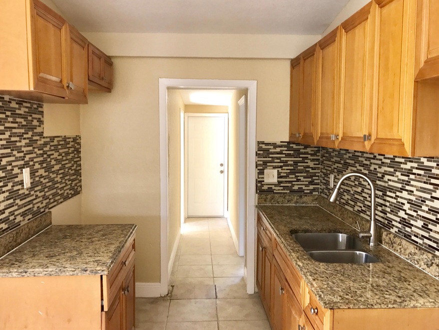 KITCHEN W GRANITE COUNTER & BACKSPLASH
