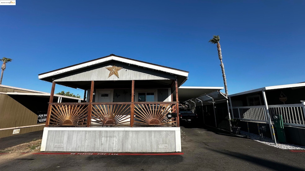 Manufactured / mobile home featuring an attached carport