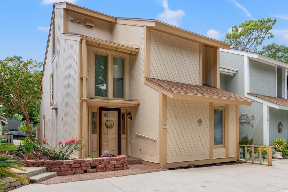 View of front of home with roof with shingles